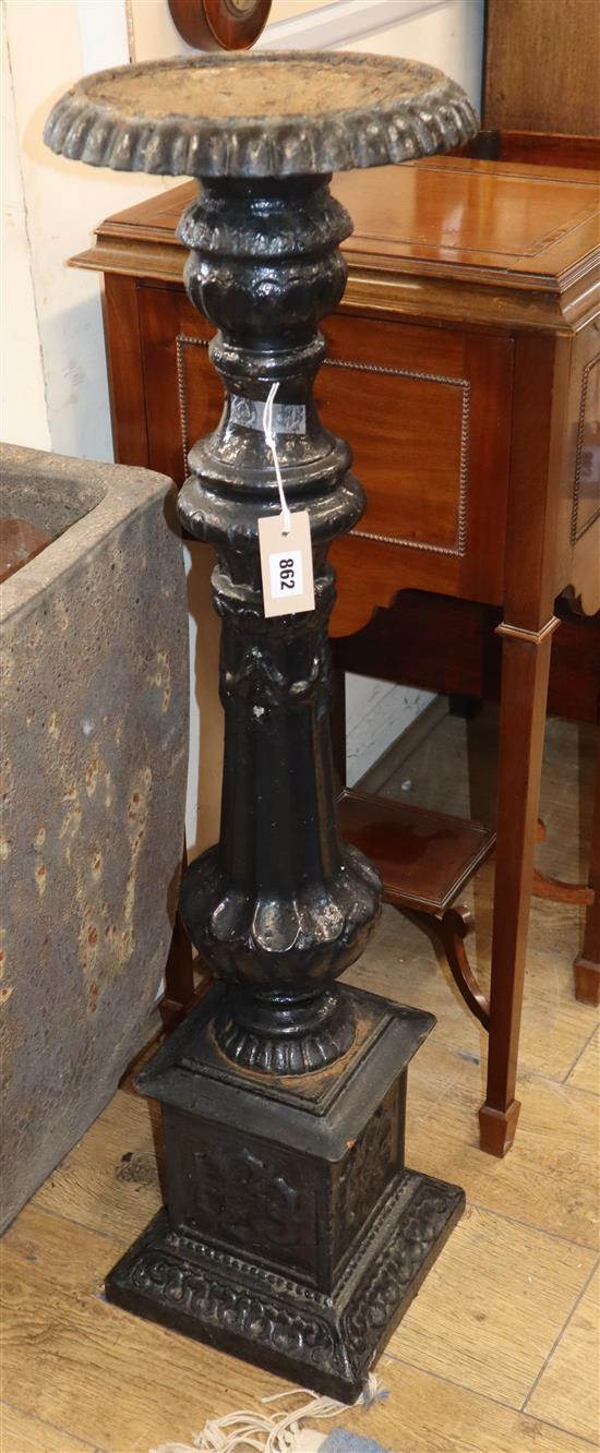 A Victorian black painted cast iron candlestand H.100cm